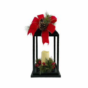 Black Lantern with LED Candle. Red Christmas Bow top and Greenery. 19" high lantern. 6" high LED candle.