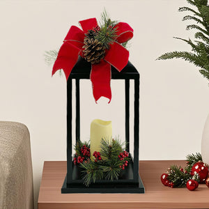 Black Lantern with LED Candle. Red Christmas Bow top and Greenery. 19" high lantern. 6" high LED candle.