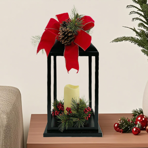 Black Lantern with LED Candle. Red Christmas Bow top and Greenery. 19" high lantern. 6" high LED candle.